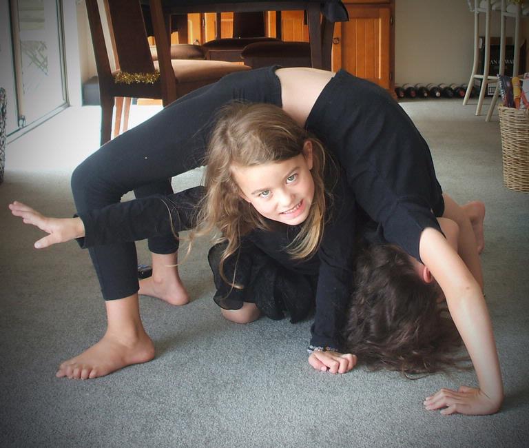 Jane Scorey; girls acrobatics; Teeana and Sarah practising their acrobatic moves at Half Moon By, Auckland.